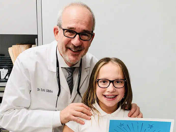Dr. Gibbs with a young braces patient for emergency orthodontic care at Gibbs Orthodontic Associates on the Upper East Side